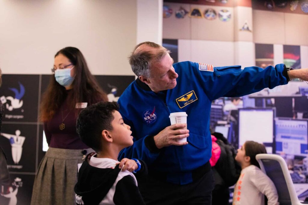 NASA astronauts Michael Foale with a young visitor at Life Science Centre in 2021.
