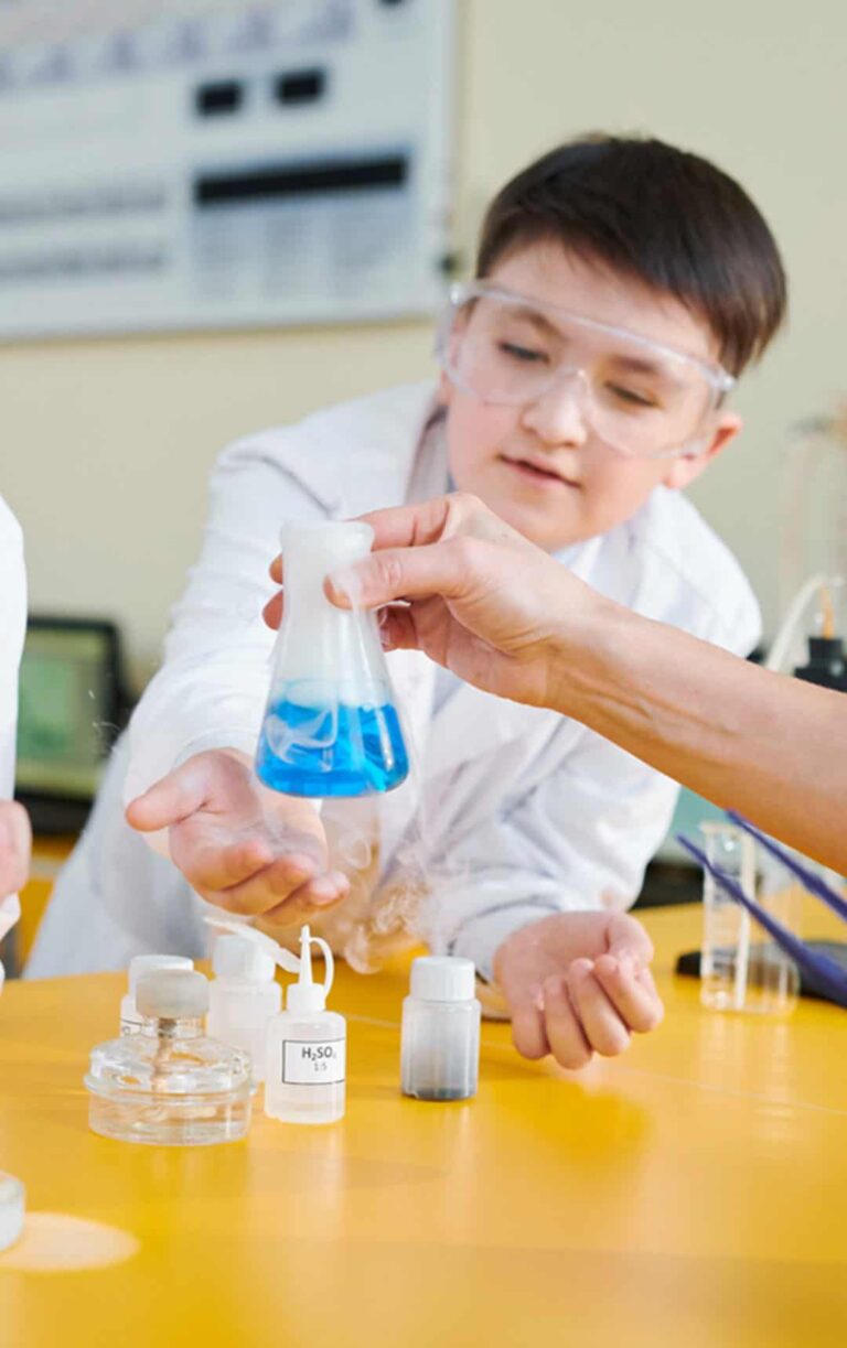 School students with Explainer completing Discovering Chemistry workshop.