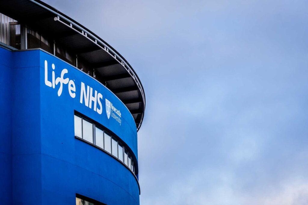 Exterior photo of Centre for Life, showing our partner logos, NHS and Newcastle University.
