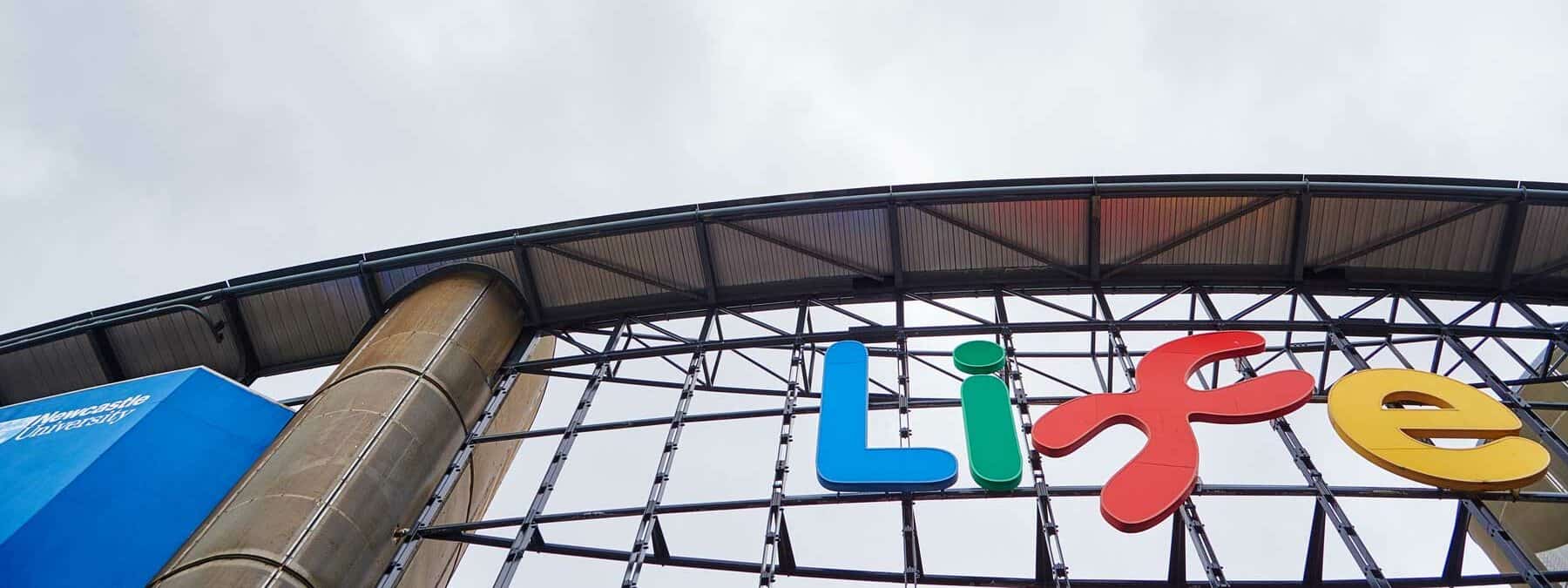 External photo of Life logo in front of Times Square