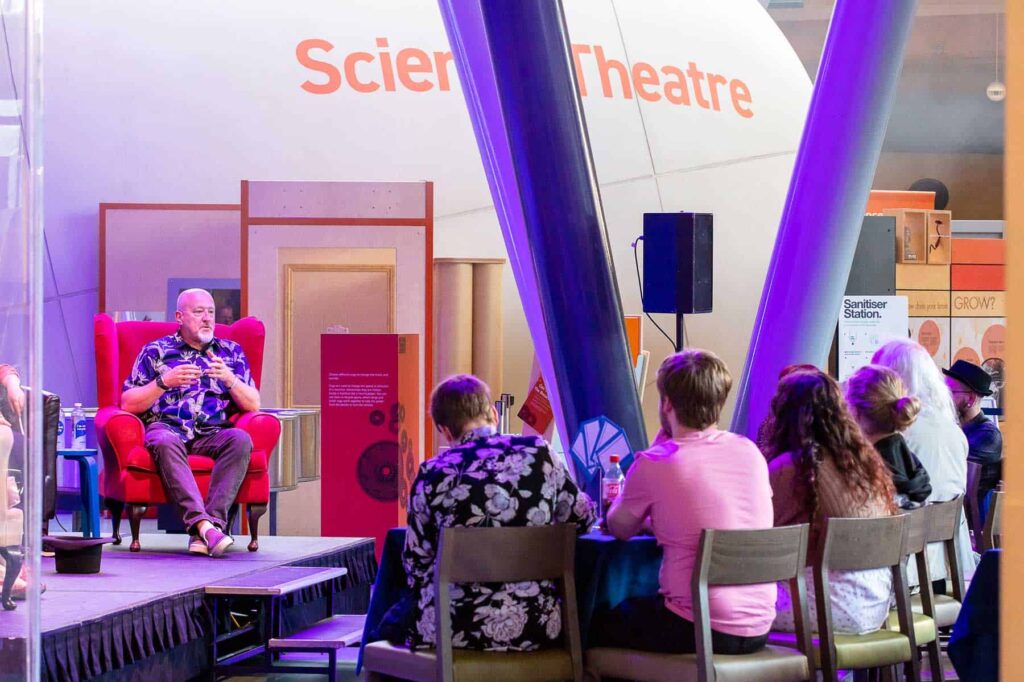 Panelist Answering A Question To Audience Member During Science Speakeasy.