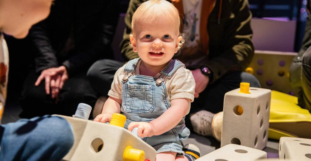 Small child playing with building blocks at Life Science Centre pre-school day.