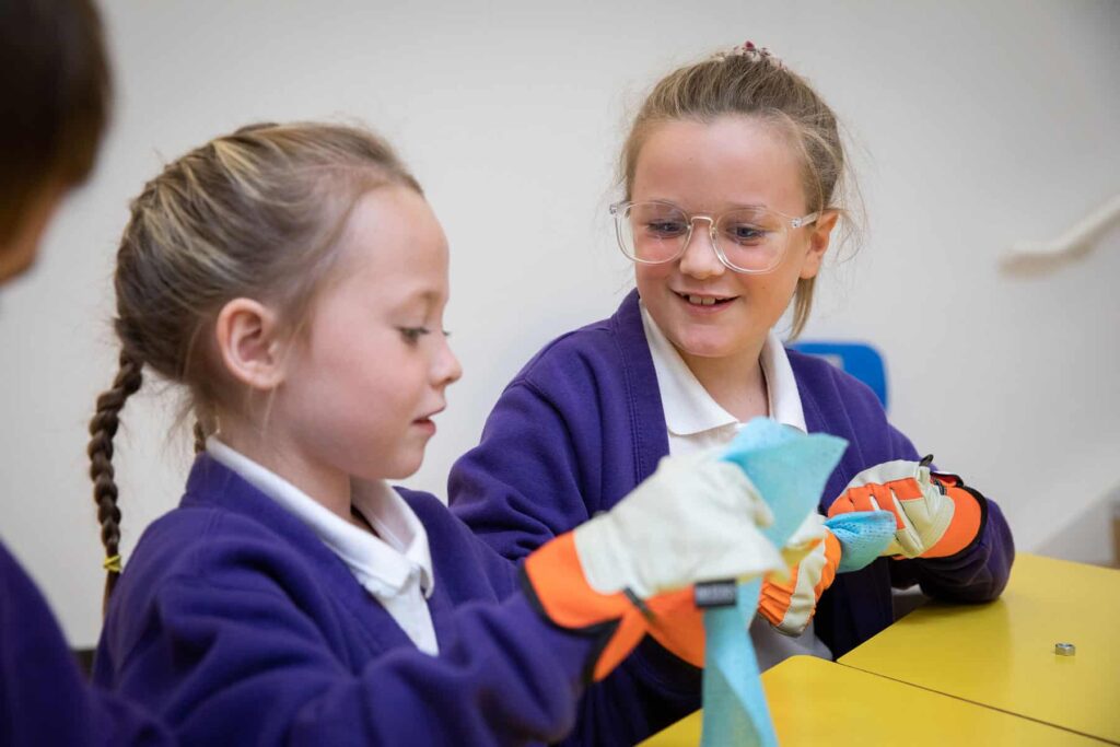 School Children Observing Different Materials In Life Science Centre's Living In Space Workshop.