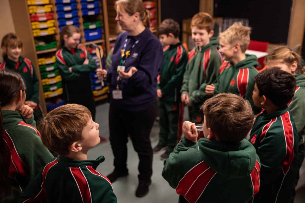 Explainer delivering a science demonstration to KS2 pupils during an education workshop about electricity.