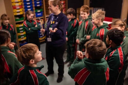 Explainer delivering a science demonstration to KS2 pupils during an education workshop about electricity.