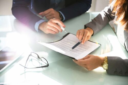 Two Businesspeople Analyzing Document