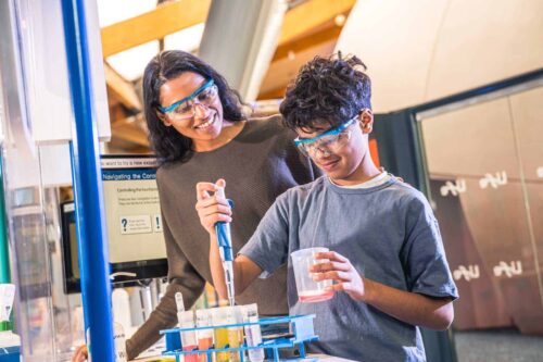 Mother And son completing hands-on science activity in Experiment Zone.