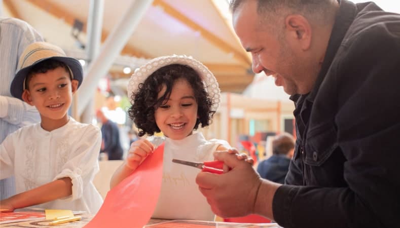 A family in Life Science Centre's Making Studios enjoying a hands-on activity whilst also supporting the charity through their membership.