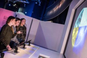 A group of visitors in Life's Space Zone, enjoying a hands-on exhibit.