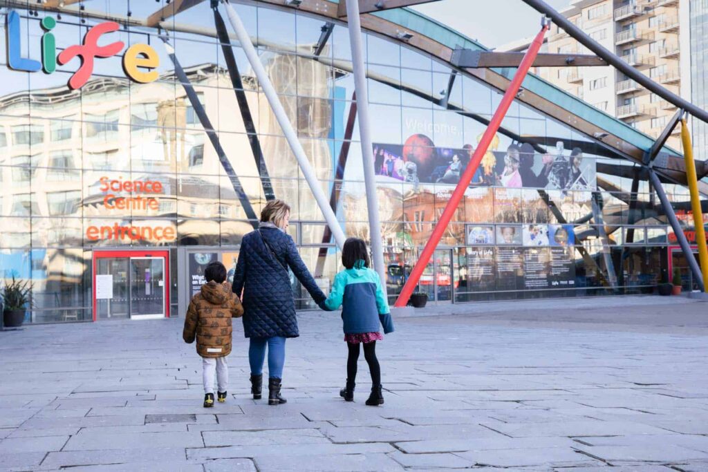 Family approaching the entrance of Life Science Centre for a fun day out