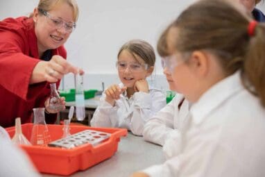 School children in a laboratory taking part in a practical education workshop inside the science centre.