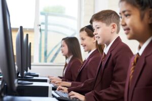 Pupils Wearing School Uniform In Computer Class