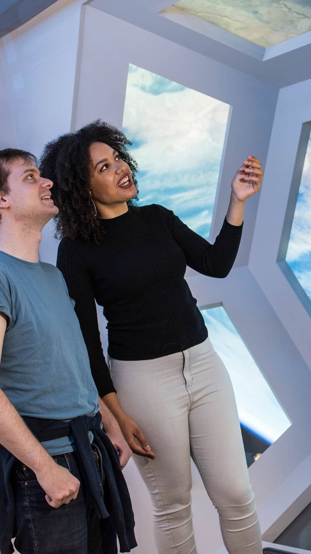 Adults in mock-up International Space Station at Life's Space Zone.