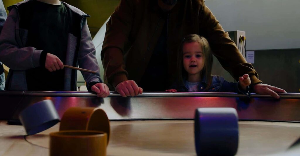 Little girl enjoying Life Science Centre's spinning table activity.