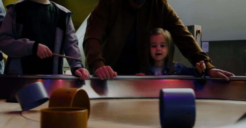 Little girl enjoying Life Science Centre's spinning table activity.