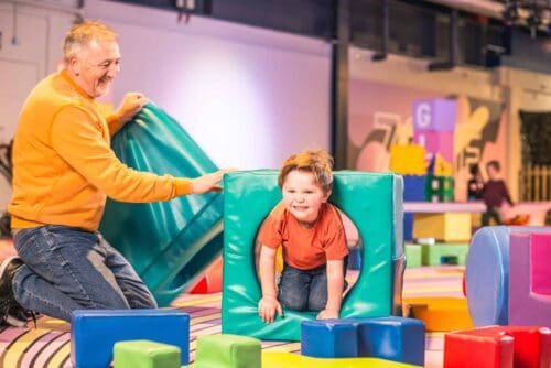 Grandad and grandson playing is soft play area at Life Science Centre