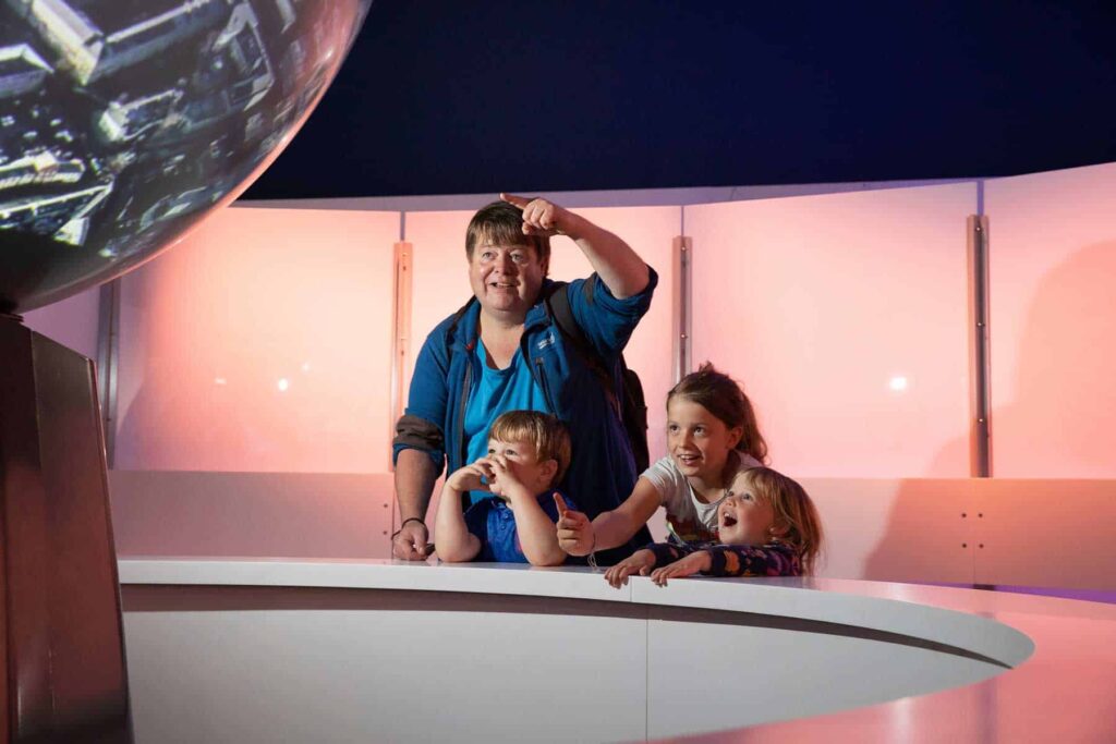 Family watching a digital show on Life Science Centre's immersive Sphere.