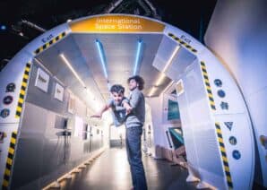 Father And Son At The Entrance To The Mock Up International Space Station.
