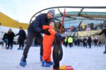 Father and son in winter clothes having a skate on Life's open-air ice rink.
