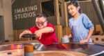 Two older childing enjoying Life Science Centre's spinning table.