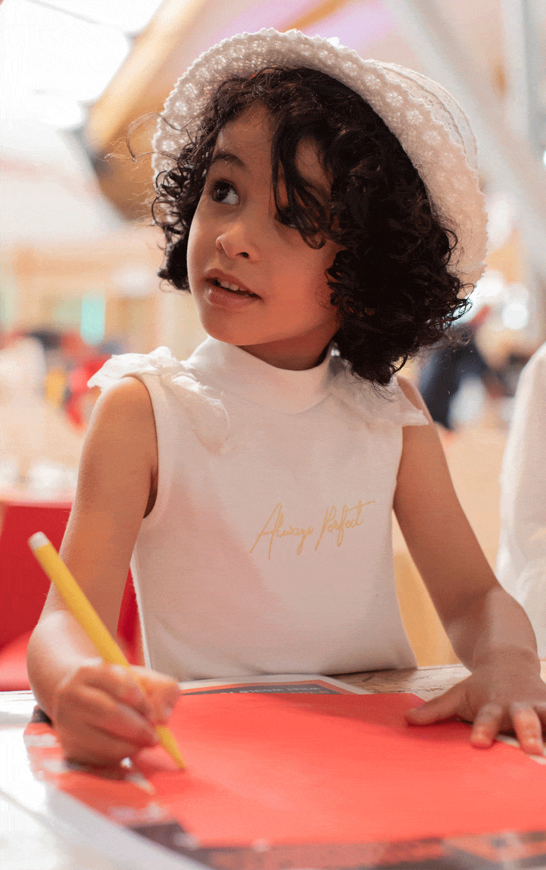 Little girl completing a craft activity with paper in The Making Studios