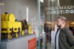 Man Looking At LEGO Replica Of Stevenson's Rocket in Creativity Zone.
