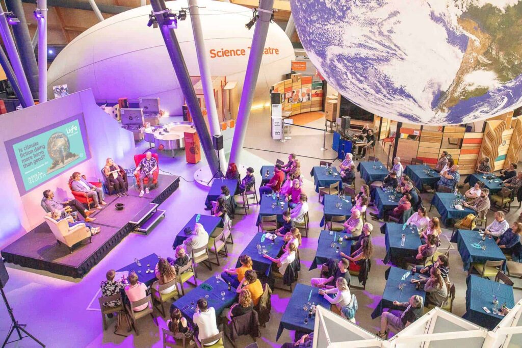 Overhead Shot Of Adults Watching Science Speakeasy Inside The Science Centre.