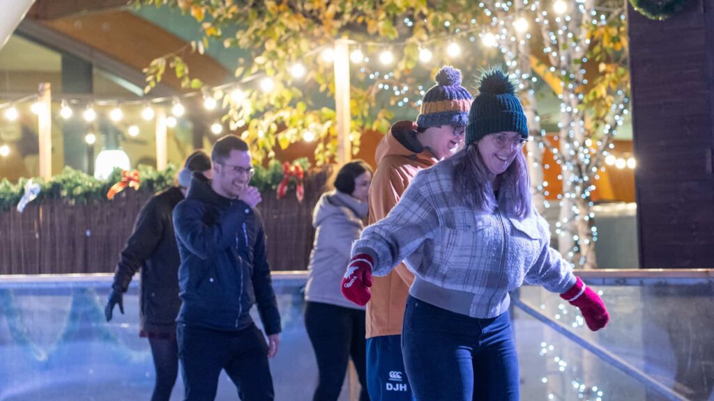 Friends skating on Life Science Centre's Newcastle city centre outdoor ice rink