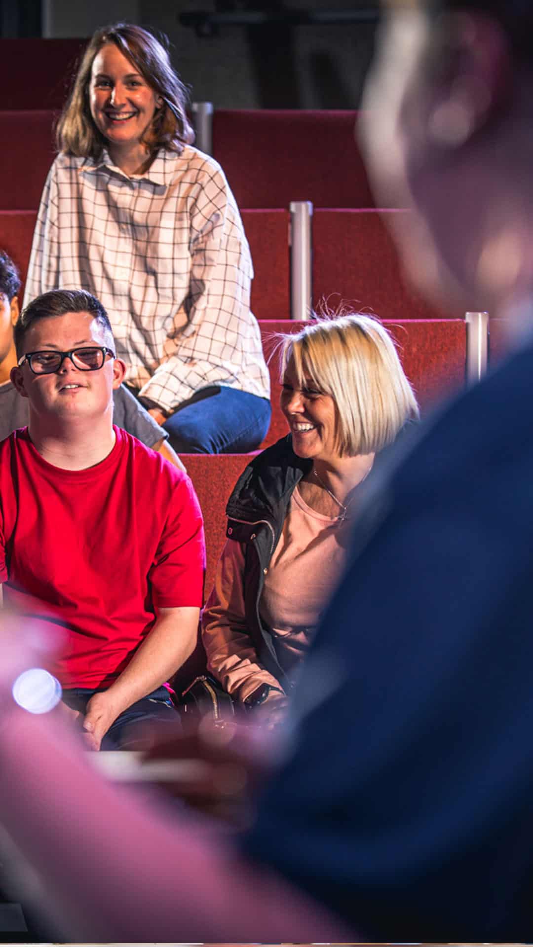 Visitors laughing during a live science show.