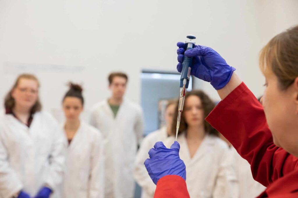 Life Science Centre demonstrator in front of a school group completing a PCR workshop.