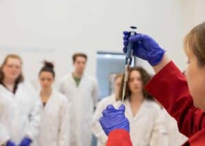 Life Science Centre demonstrator in front of a school group completing a PCR workshop.