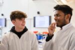 Two male students carrying our PCR test during a Key Stage 4 schools' workshop.