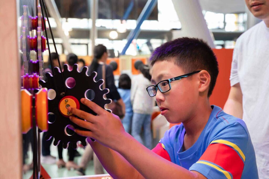 Child Playing With Gears In Creativity Zone