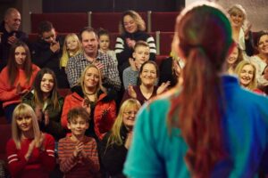Audience clapping whilst watching an Explainer in Life's Science Theatre.