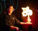 An explainer using flames in live science show inside Life Science Centre.