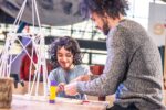 Father And Son making a sculpture using paper straws in Life Science Centre's Making Studios.