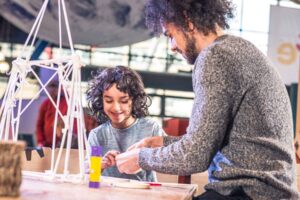 Father And Son making a sculpture using paper straws in Life Science Centre's Making Studios.