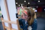 Girl drawing on easel in Life Science Centre's Hello World.