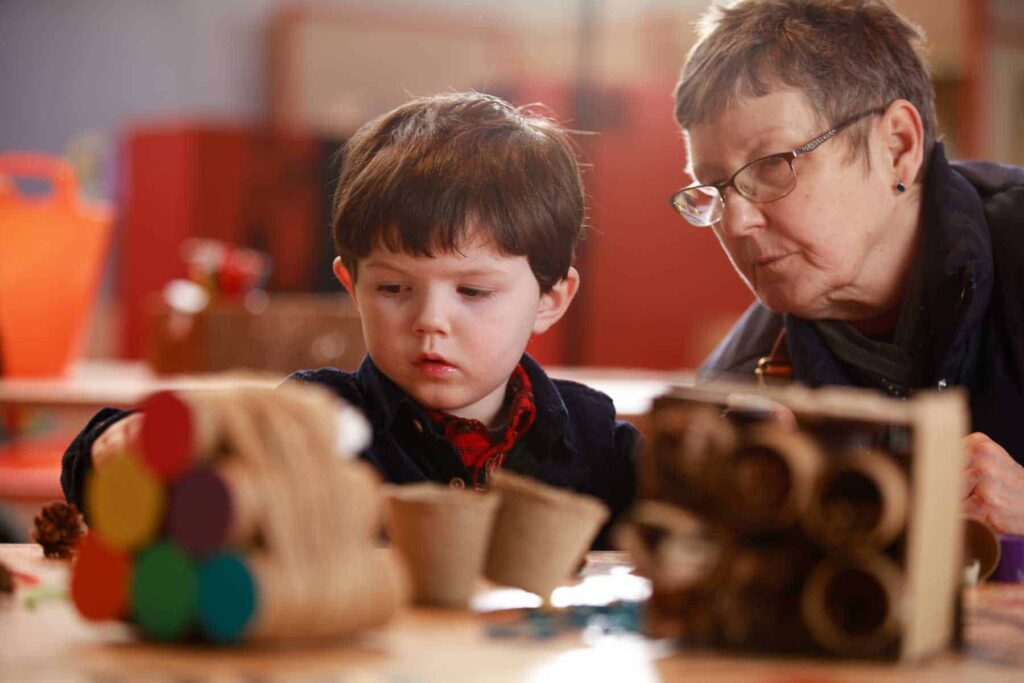 Grandma And with grandson creating a selfie portrait using string in Life Science Centre's Making Studios.