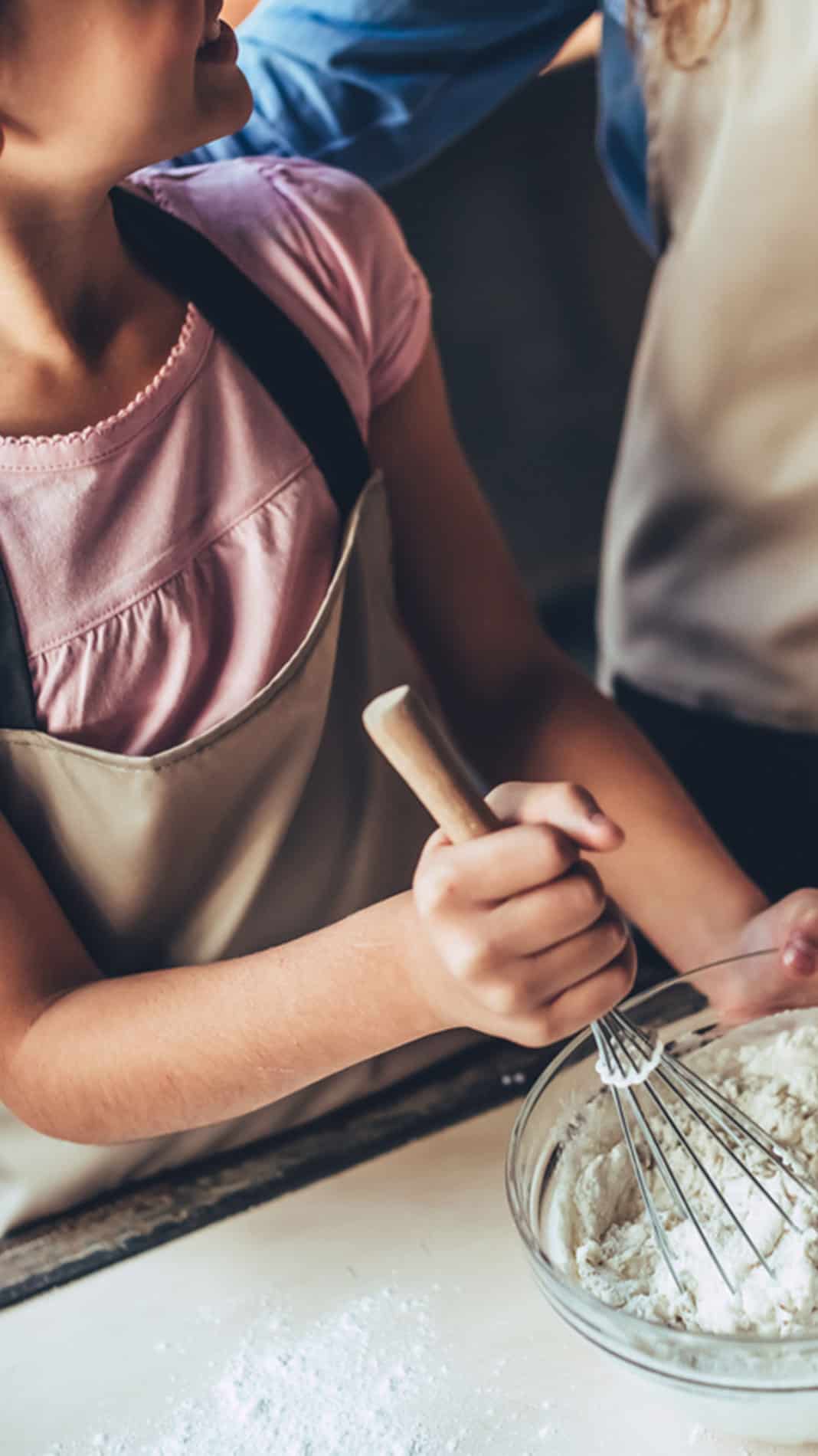 Mum with daughter in kitchen making home-made ice cream.
