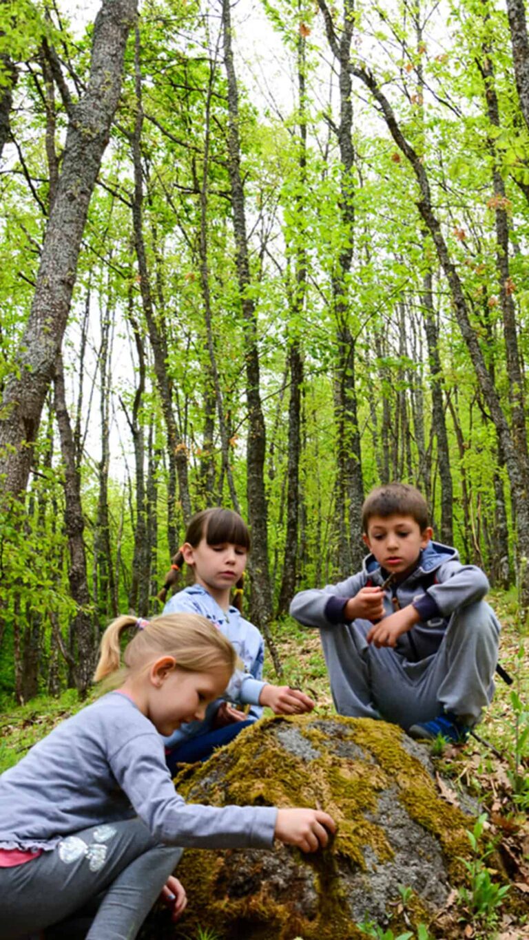 Brothers And sister outside on a spring scavenger hunt.
