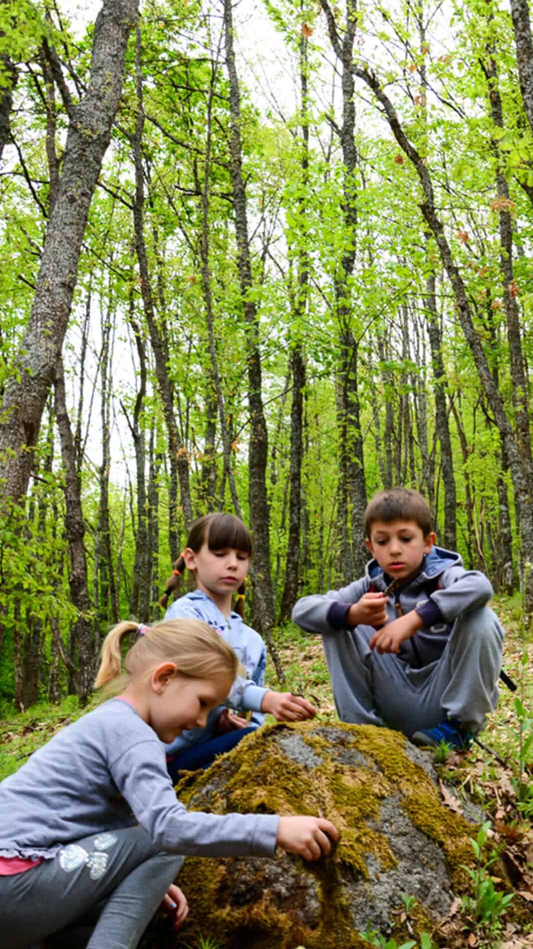 Brothers And sister outside on a spring scavenger hunt.