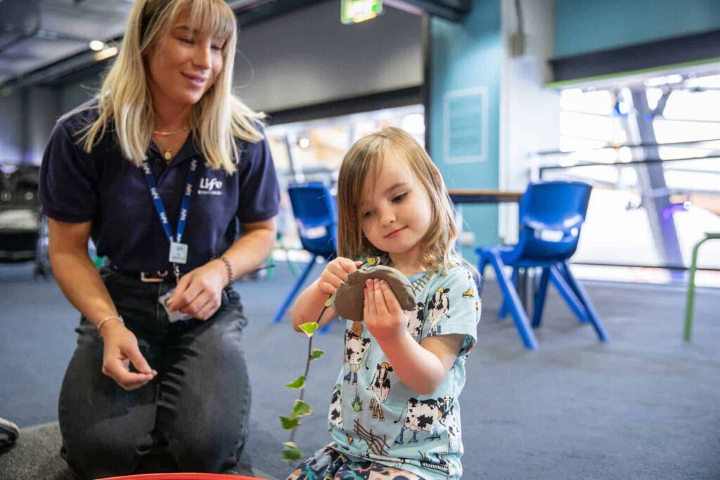 Younger Visitor Enjoying Clay Leaf Printing At Pre School Day