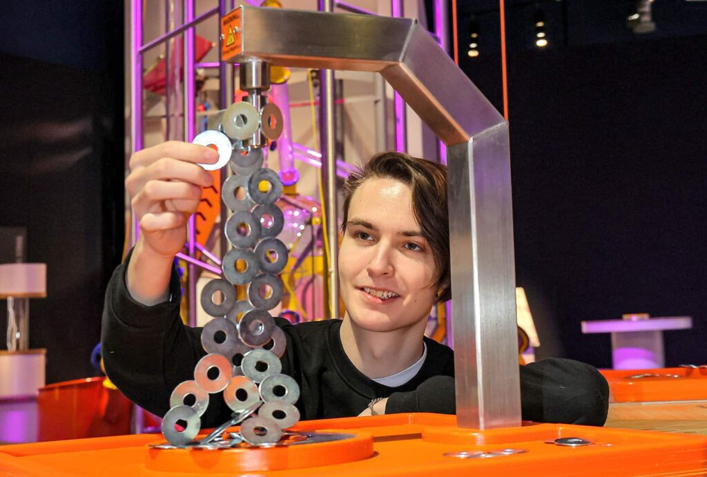 Adult male experimenting with magnets in Life's Wow Zone.