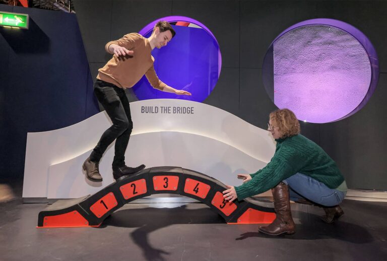 Adults building bridge in Life's Wow Zone.