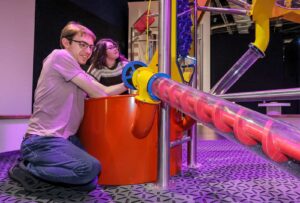 Adults operating Big Machine in Life's Wow Zone.