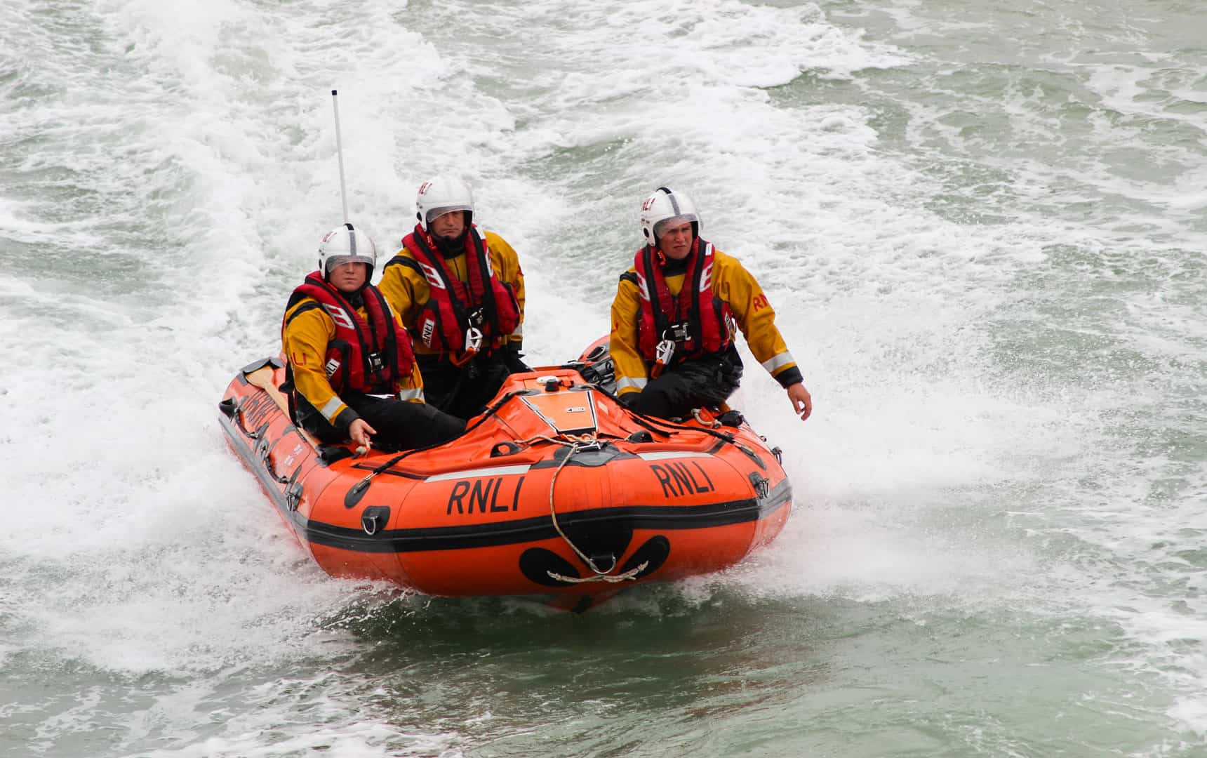 Eastbourne, UK - 17 August, 2013: Royal National Lifeboat Institution (RNLI) in-shore crew on duty at the Eastbourne Air Show on the English Channel, UK on 17 August, 2013.