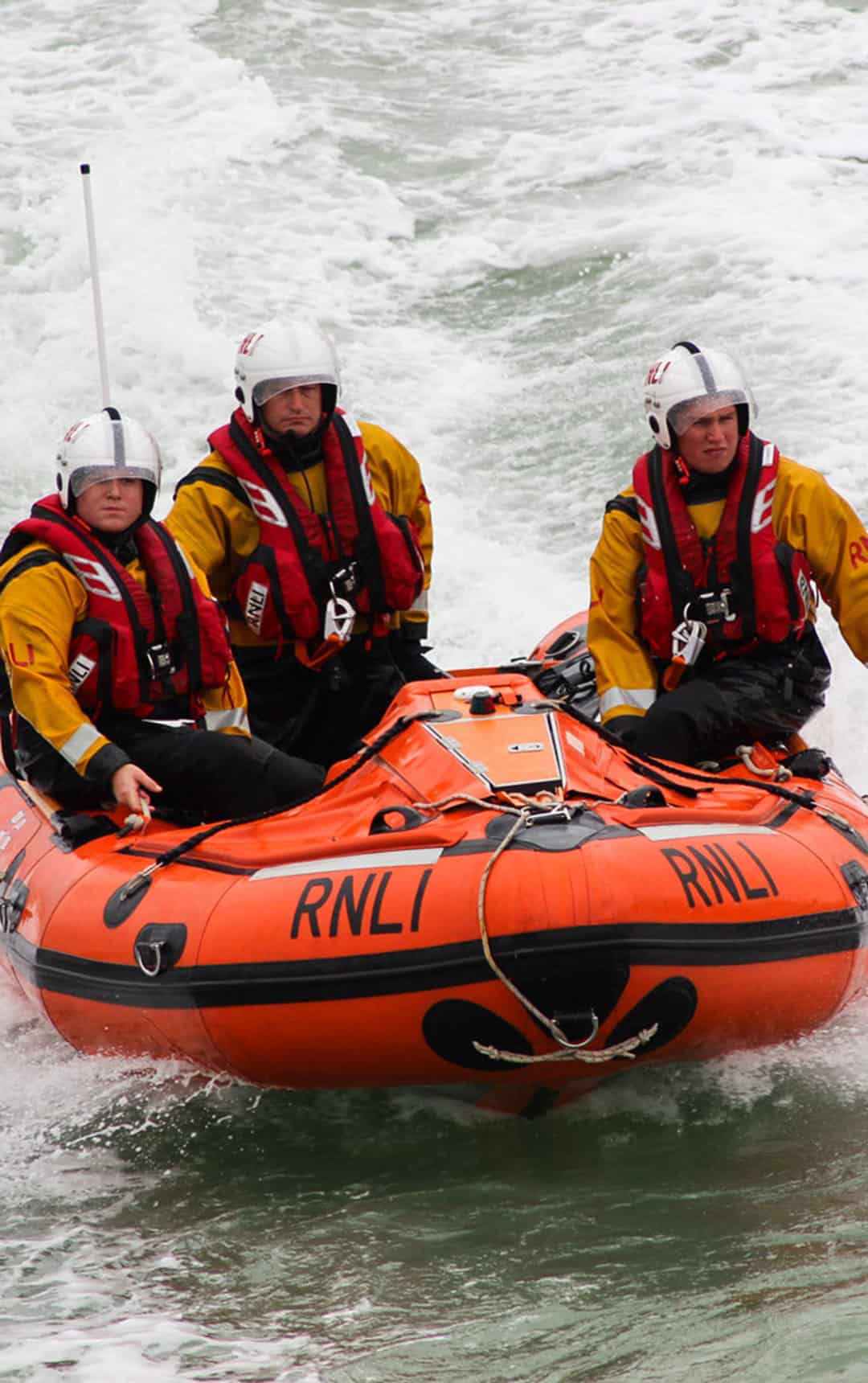Eastbourne, UK - 17 August, 2013: Royal National Lifeboat Institution (RNLI) in-shore crew on duty at the Eastbourne Air Show on the English Channel, UK on 17 August, 2013.