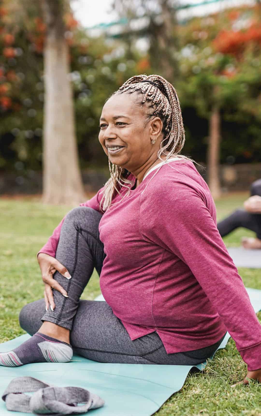 women doing yoga exercise with social distance for coronavirus outbreak at park outdoor - Healthy lifestyle and sport concept stock photo