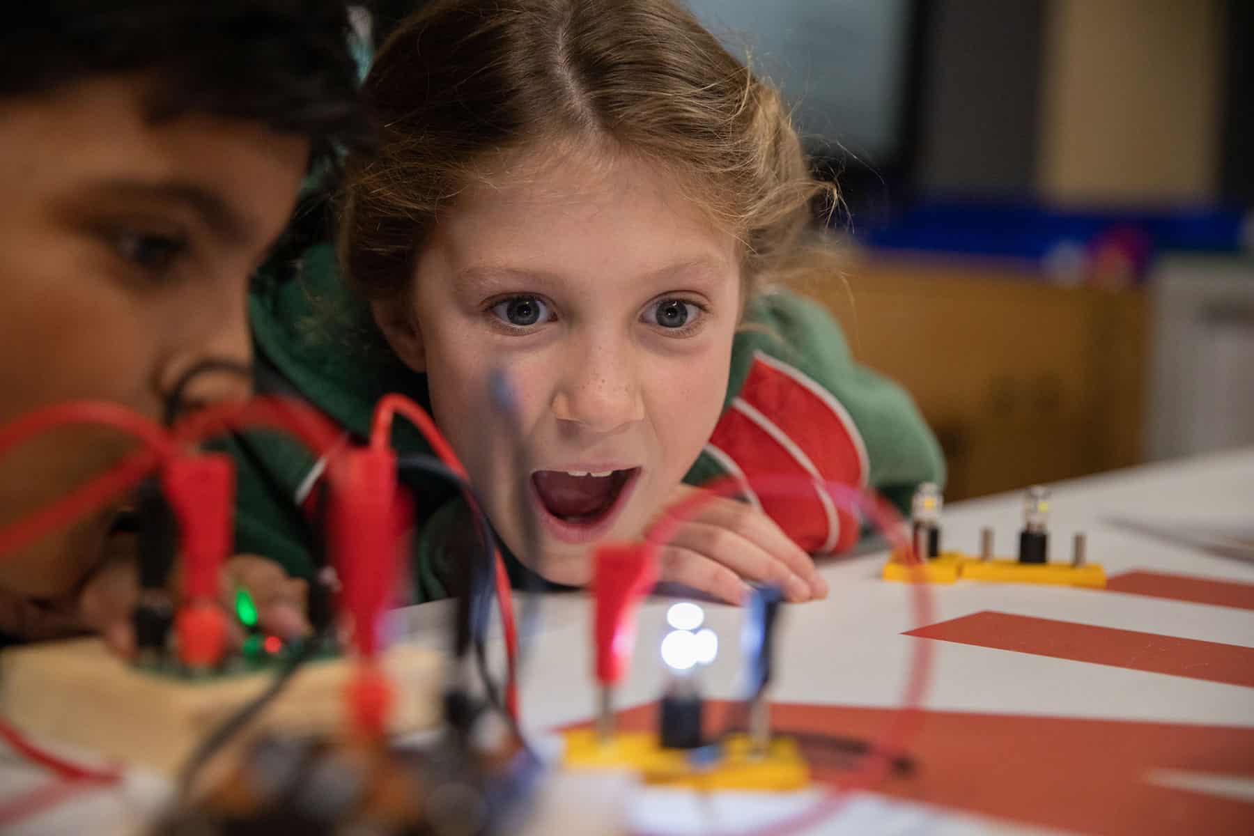 Female student looking amazed at scientific demonstration during a Life Science Centre workshop.